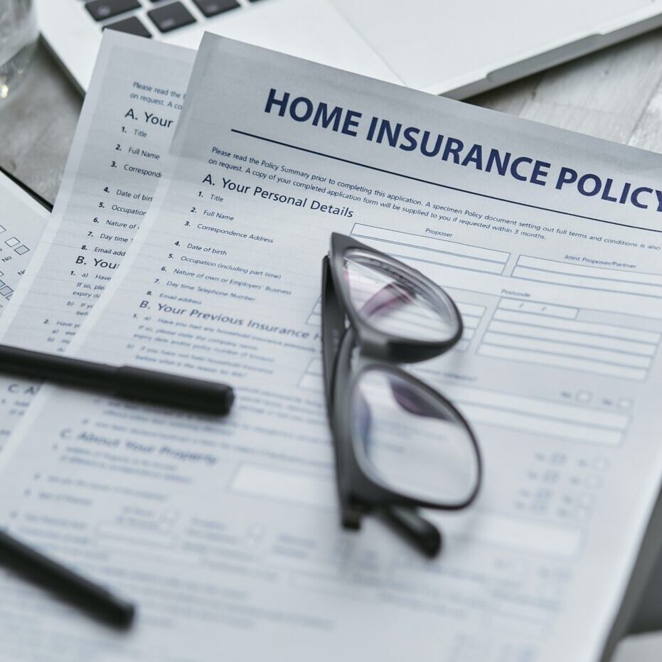 Insurance paperwork with glasses sitting on top